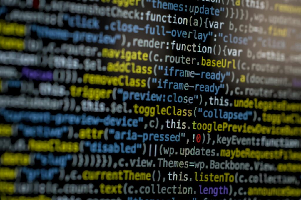 An extreme close-up of colorful programming code on a computer screen, showcasing development and software debugging.